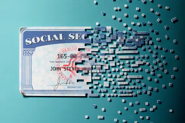 social security card breaking up into bits and floating away
