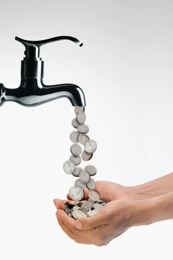 Coins flowing from tap