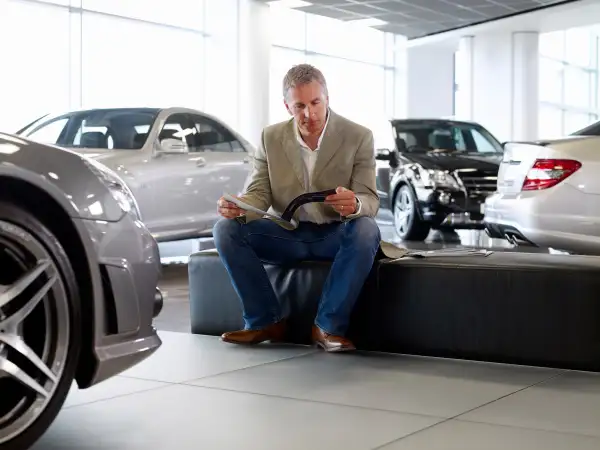 man in car dealership showroom