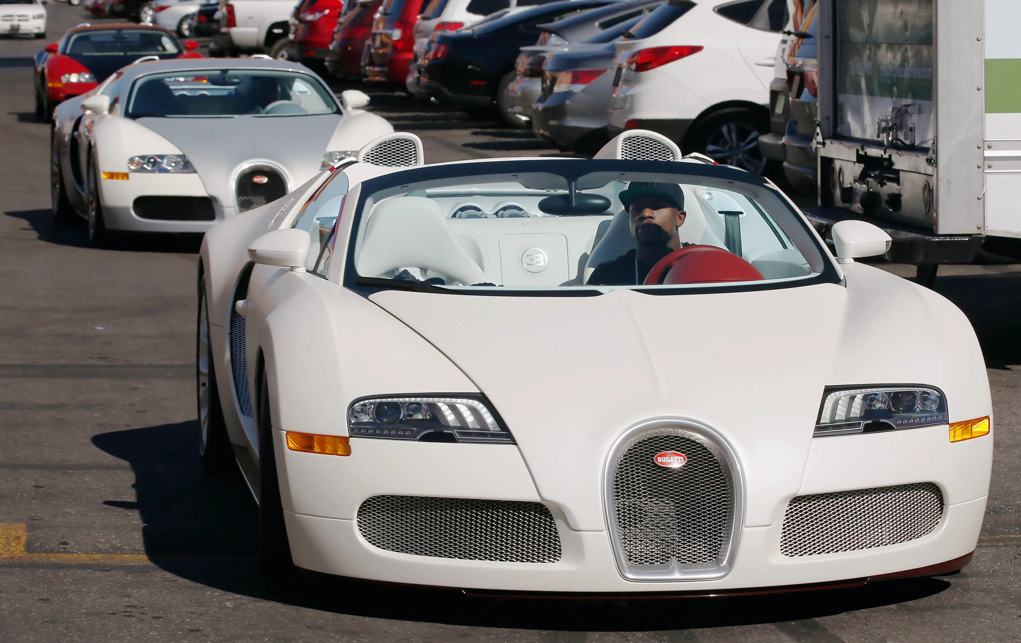 Boxer Floyd Mayweather Jr. (L) arrives in his Bugatti for a work out at the Mayweather Boxing Club on September 2, 2014 in Las Vegas, Nevada.