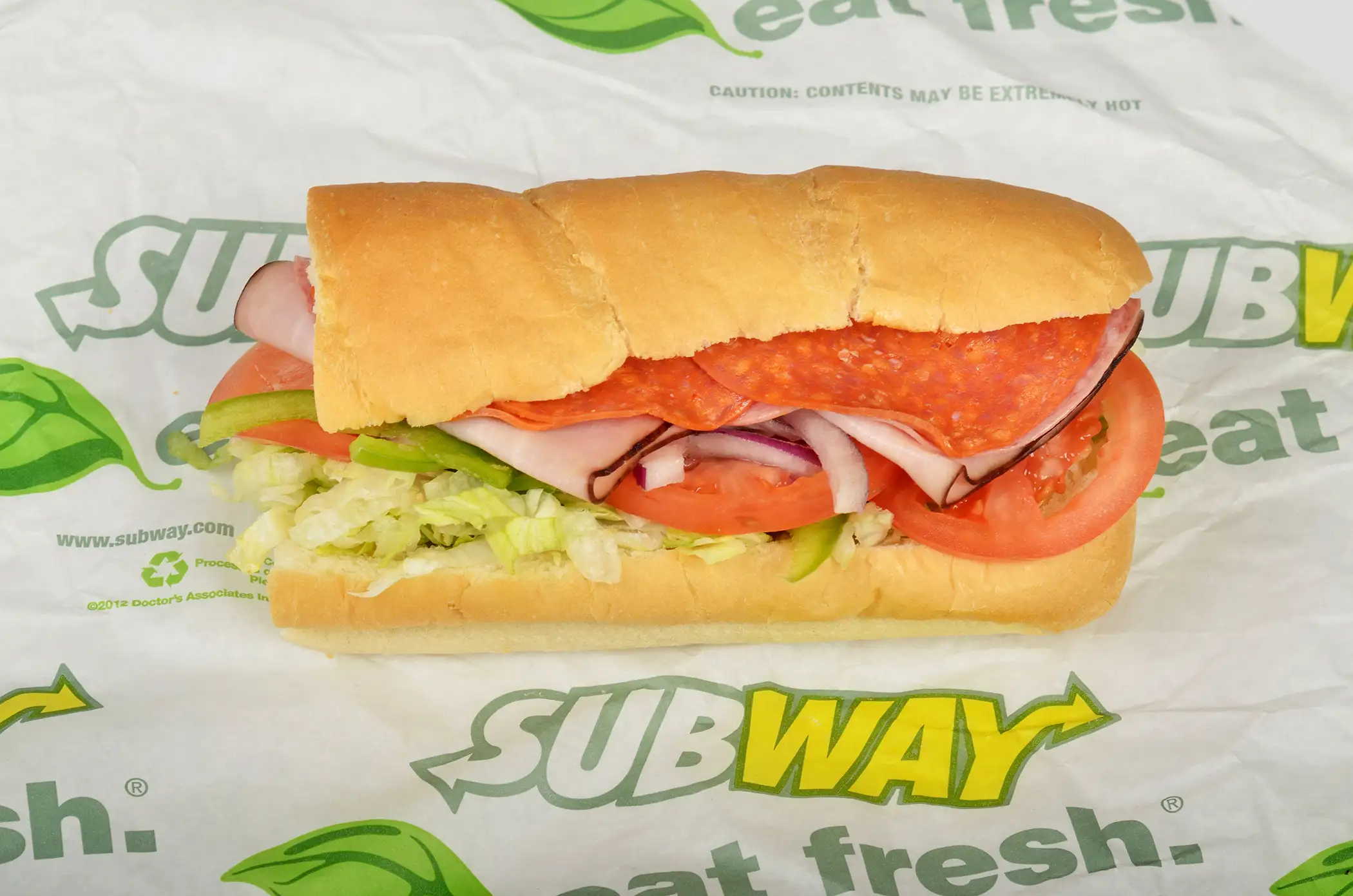 Subway BMT sub sandwich on italian roll with Genoa Salami, Black Forest Ham, Pepperoni, lettuce, tomato, red onion on roll.