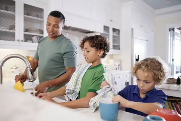 father and sons doing dishes
