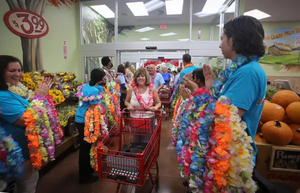 Robin Gallo (center) of North Palm Beach attended the opening on the new Trader Joe's store in Palm Beach Gardens store Friday, September 19, 2014. ''I got here at 6am and was the first in line, '' she said. ''I am using half a vacation day for this.