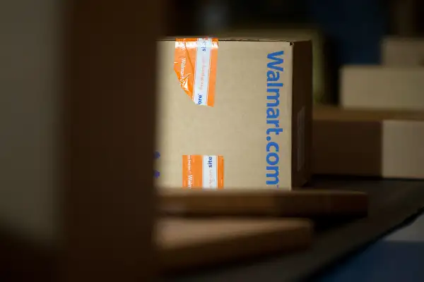 A Wal-Mart Stores Inc. package is unloaded from a trailer to be sorted for final delivery at a FedEx Corp. Ground hub in Hagerstown, Maryland, U.S.