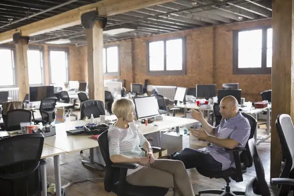 man and woman in startup company having conversation