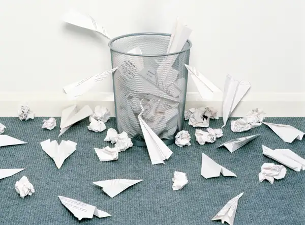 paper airplanes crashing around trashcan