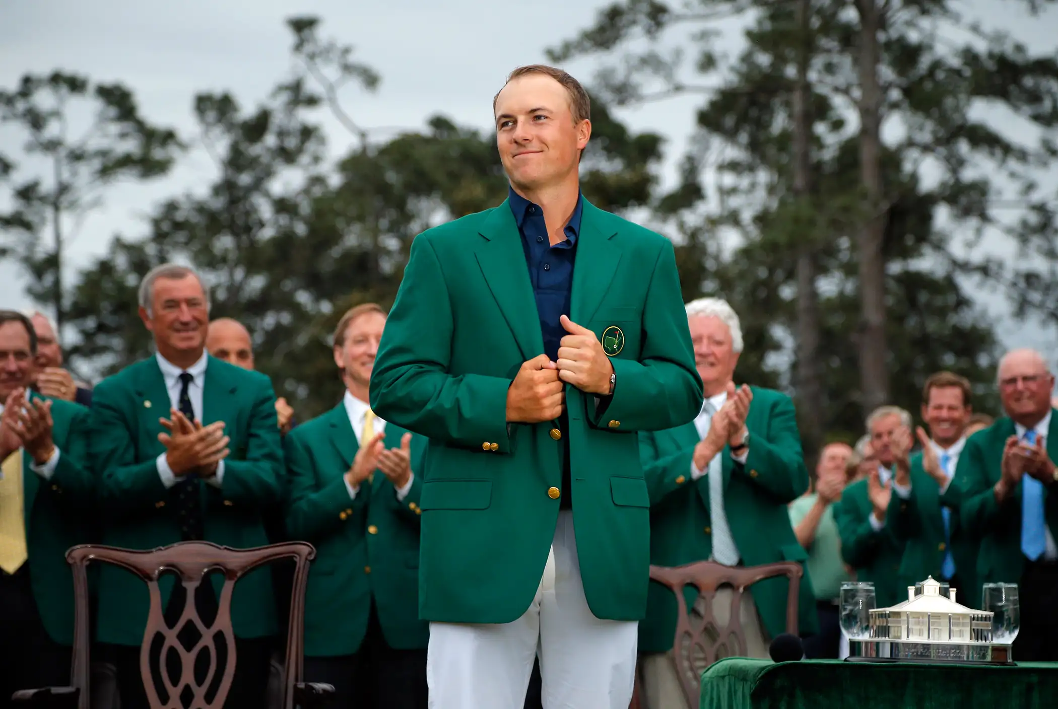 Jordan Spieth of the U.S. grins as he wears his Champion's green jacket on the putting green after winning the Masters golf tournament at the Augusta National Golf Course in Augusta, Georgia April 12, 2015.