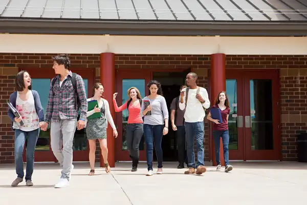 high school students walking out of school