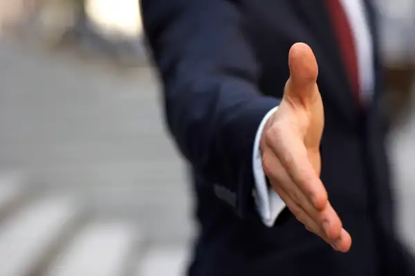 businessman extending hand for handshake