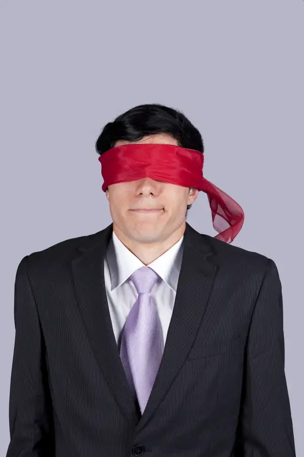 blindfolded man in suit
