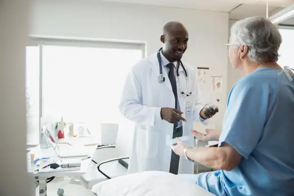 Doctor prescribing medication to senior man