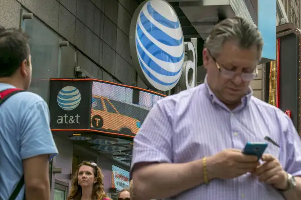 A man uses his phone outside the AT&amp;T store in New York's Times Square, June 17, 2015.