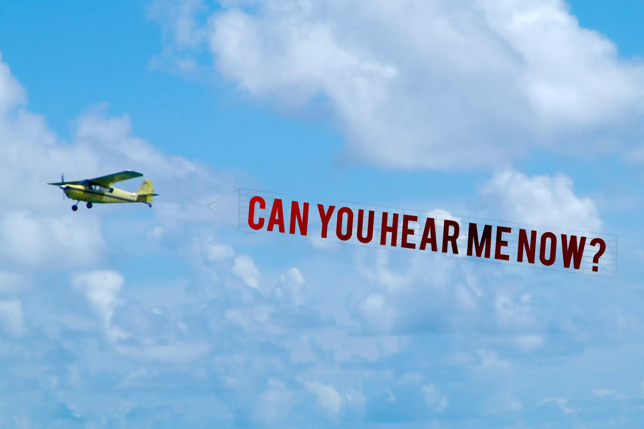 airplane with banner flying behind it that reads &quot;can you hear me now?&quot;