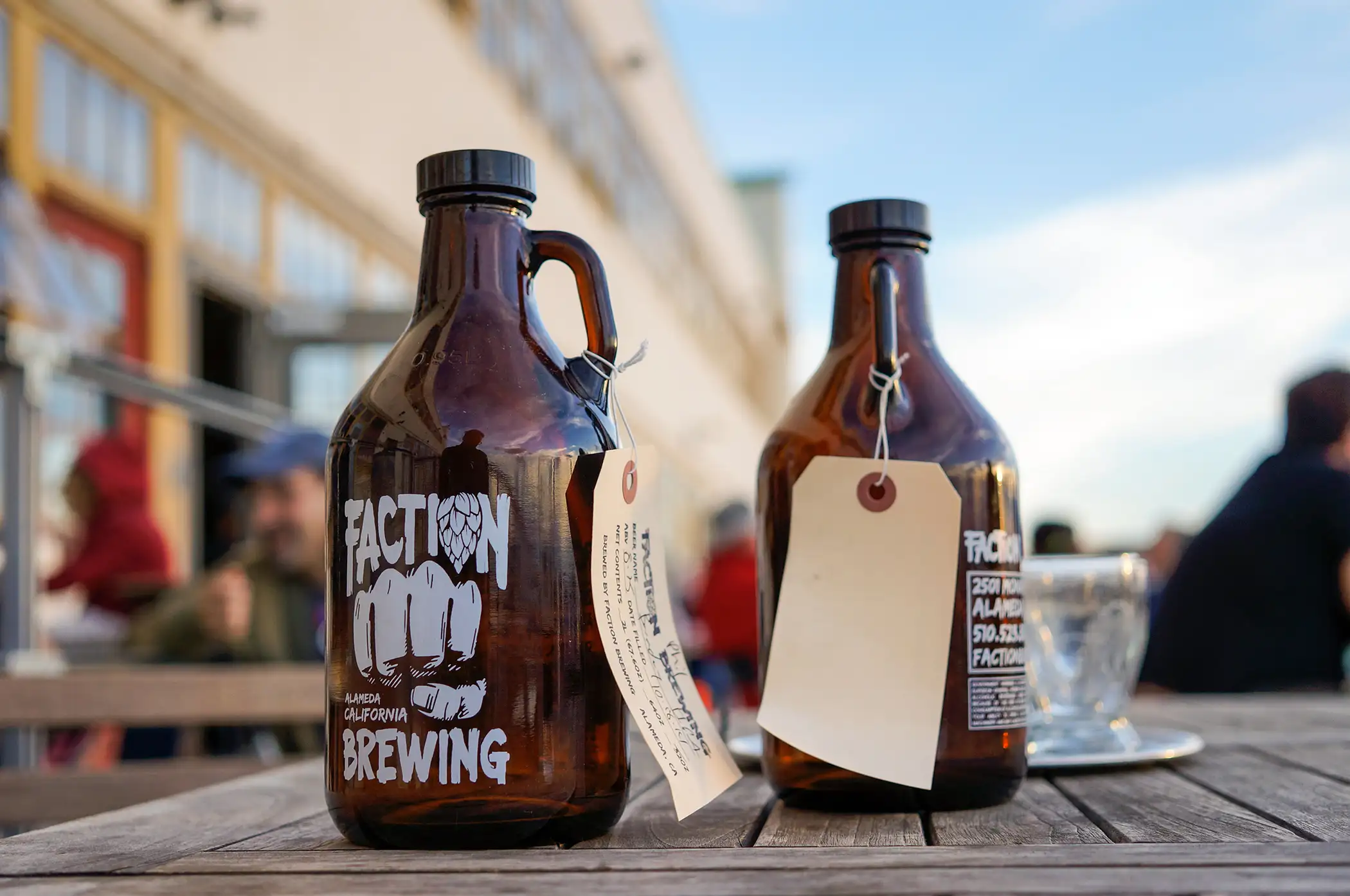 Growlers on a table outside Faction Beer Brewery, Alameda, California
