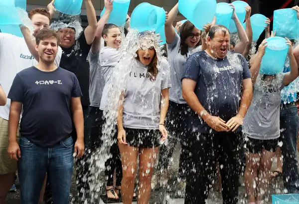 Ken Little, VP Engineering at Tumblr, Katherine Barna, Head of Communications at Tumblr, and Lee Brown, Head of Global Sales at Tumblr accept the ALS Ice Bucket Challenge during the ringing of the opening bell at the NASDAQ MarketSite on August 21, 2014 in New York City.