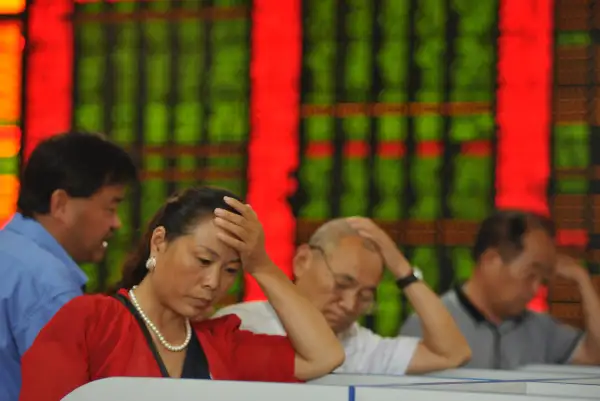 Investors watch computer screens at a stock exchange hall on August 18, 2015 in Fuyang, China. Chinese shares plunged on Tuesday with the benchmark Shanghai Composite Index down 245.51 points, or 6.15 percent, to close at 3,748.16. The Shenzhen Component Index fell 890.04 points, or 6.56 percent, to close at 12,683.86.