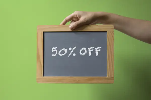 hand holding chalkboard that reads: 50% off