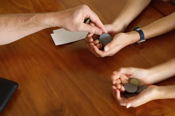 parent putting coins in child's hand