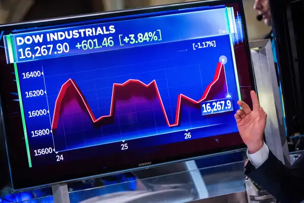 A man explains the stock market's recent fluxuations on the floor of the New York Stock Exchange during the afternoon of August 26, 2015 in New York City.