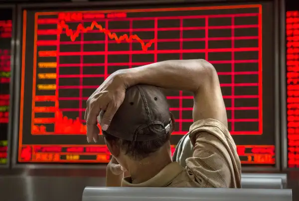 A Chinese day trader watches a stock ticker at a local brokerage house on August 27, 2015 in Beijing, China. A dramatic sell-off in Chinese stocks caused turmoil in markets around the world, driving indexes lower and erasing trillions of dollars in value.