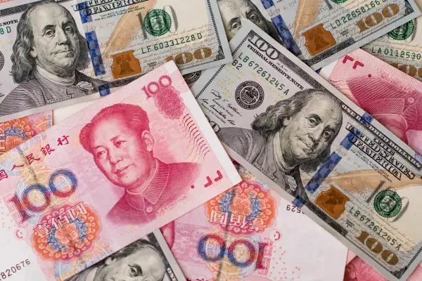 Yuan And Dollar Banknotes Ahead Of Tenth Anniversary Of China's Yuan Reform