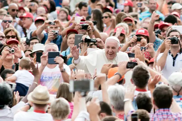 Pope Francis accompanied by his security agents, waves to faithful upon his arrival on St Peter's square at the Vatican to lead his weekly general audience on September 16, 2015.