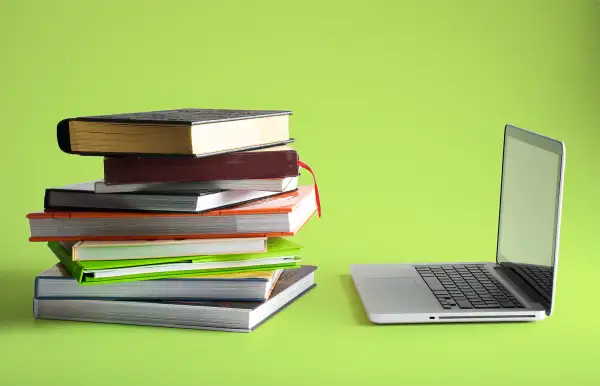 stack of books and laptop