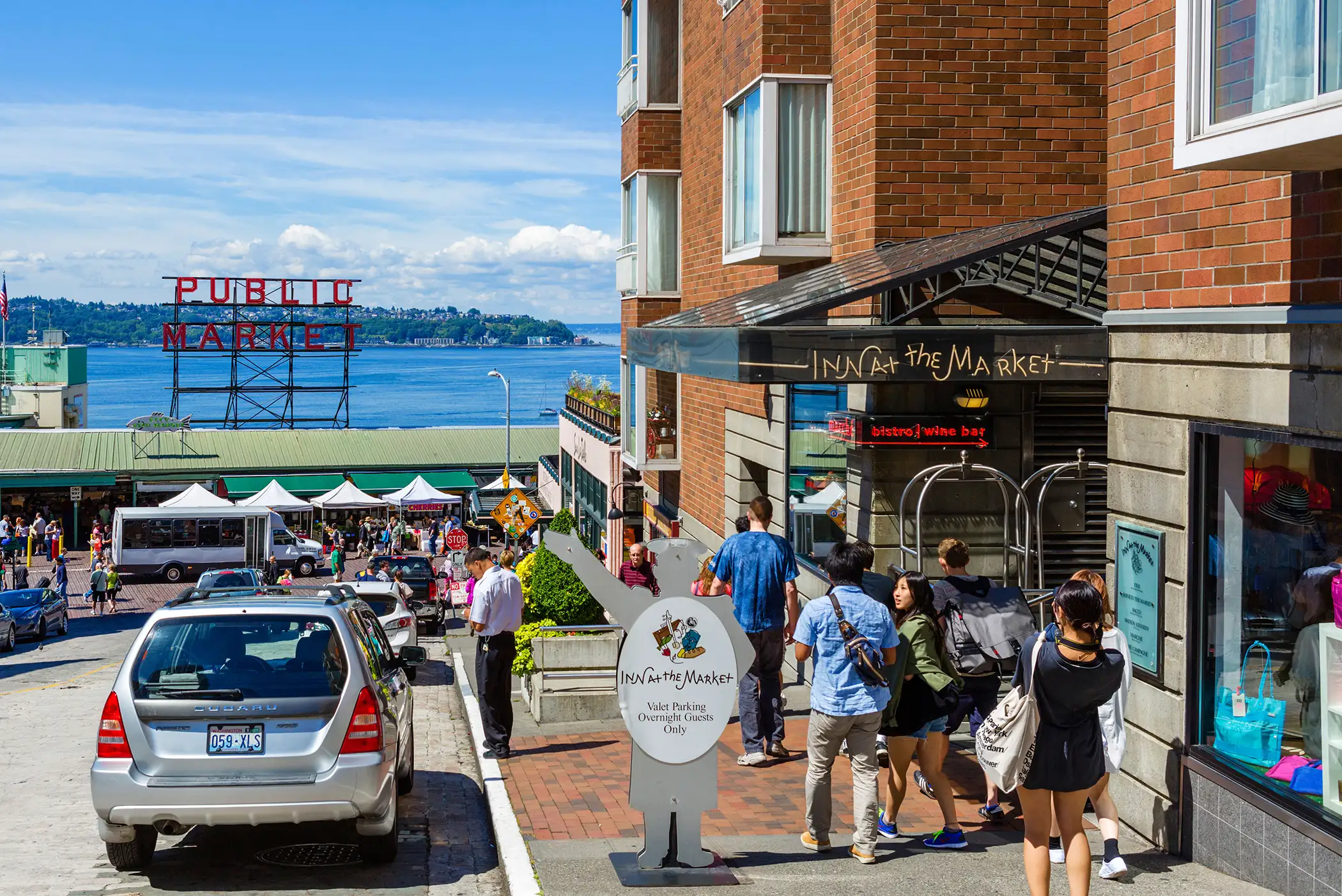 View down Pine Street of Pike Place Market with Inn at the Market in foreground, Seattle