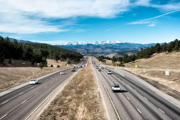 Interstate 70 leads to the snow-capped Rocky Mountains in the distance near Golden, Colorado, just outside Denver.