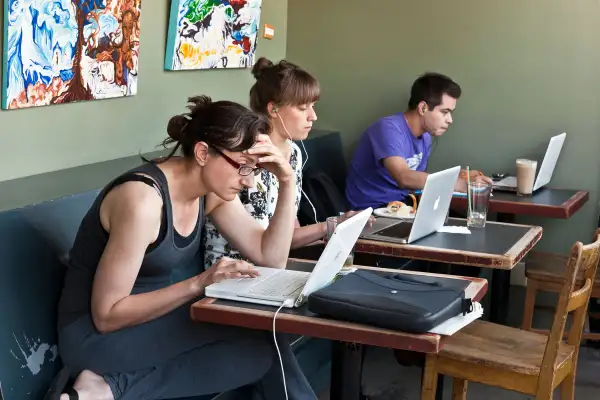 people working on computers in coffee shop