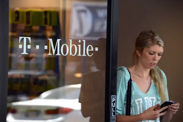 A customer exits a T-Mobile store in Glendale, California, on August 1, 2014.