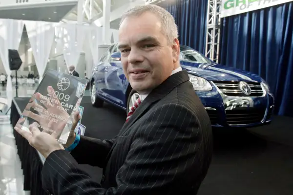 Stefan Jacoby, president and CEO Volkswagen of America, holds the 2009 Green Car of the Year award in front of the 2009 Jetta TDI at the Los Angeles Auto Show, November 20, 2008, in Los Angeles. Green Car Journal named the Jetta TDI as the  Green Car of the Year,  making it the first clean-diesel car to win the award.