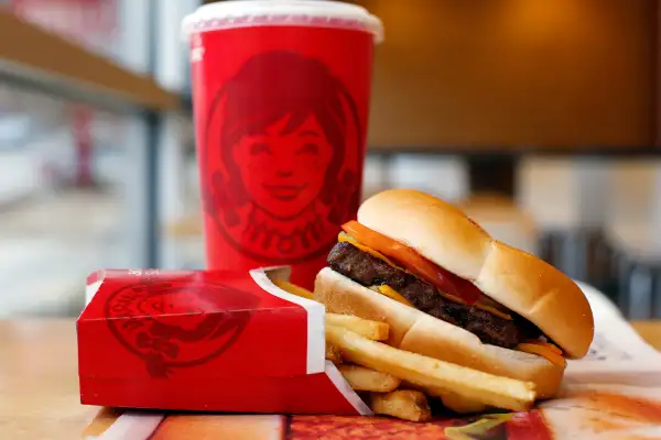 A Wendy's single hamburger with cheese, fries and a drink at a Wendy's restaurant in Pittsburgh