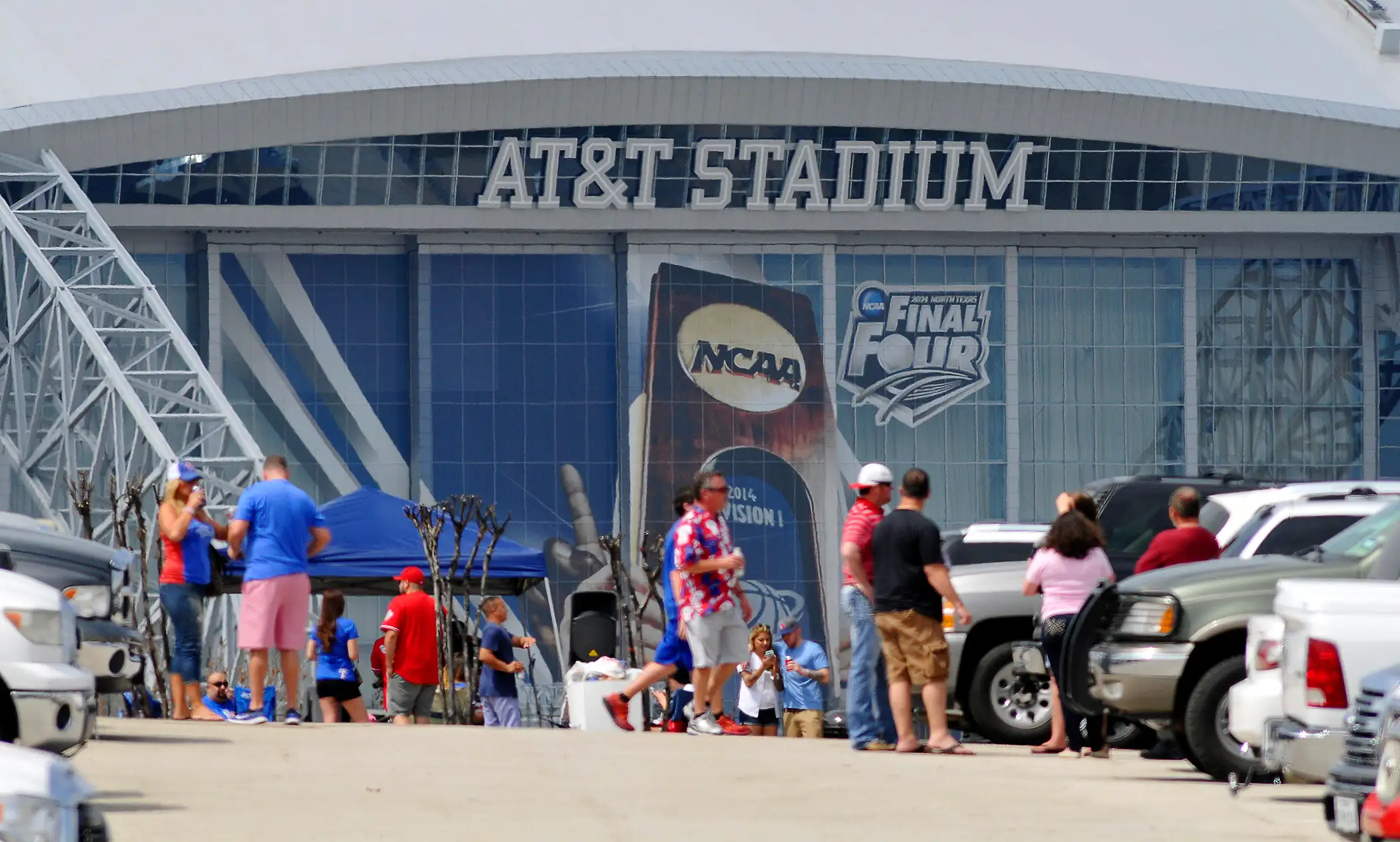 Baseball fans tailgate in the parking lots next to At&amp;T Stadium, March 31, 2014.