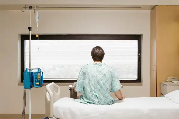 patient sitting on hospital bed