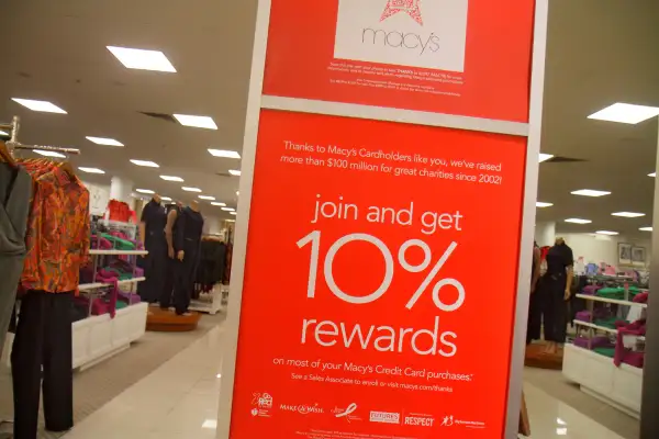 A 2014 promotional poster for a Macy's department store credit is shown in the Miami store.