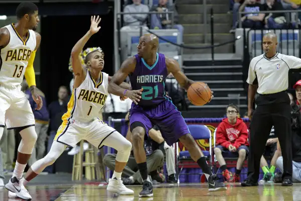 Damien Wilkins #21 of the Charlotte Hornets handles the ball against Joseph Young #1 of the Indiana Pacers on October 22, 2015 at Allen County War Memorial Coliseum in Fort Wayne, Indiana.