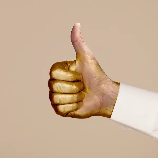 gold painted thumbs up with gold paint brushed off