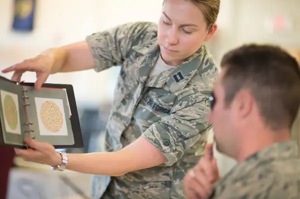 U.S. Air Force Capt. Marcy O'Neil, from the 158th Fighter Wing Medical Squadron, administers a vision exam at the Vermont Air National Guard in South Burlington, Vermont, June 6. The 158th Medical Squadron has become the first Air Guard base to process both Preventative Health Assessments and Occupational Health Physical Examinations in one large push, improving the medical experience for both sides, and creating a cost-saving and efficient format for other bases to emulate.