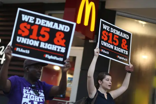 Cecelia O'Brien (R) joins other workers to protest outside a McDonald's restaurant on November 10, 2015 in Miami, Florida. The protesters are demanding action from state legislators and presidential candidates to raise the minimum wage to $15 an hour.