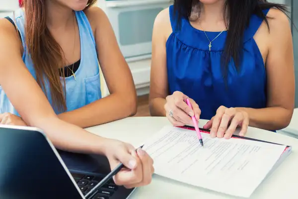 parent and teenager filling out form