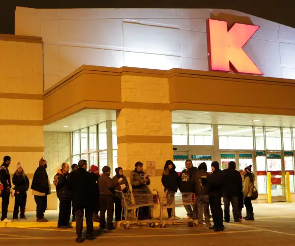 Customers line up outside a Kmart store on Thanksgiving morning, November 27, 2014 in Chicago, Ill. Kmart stores opened at 6 a.m. to kick off doorbuster savings.