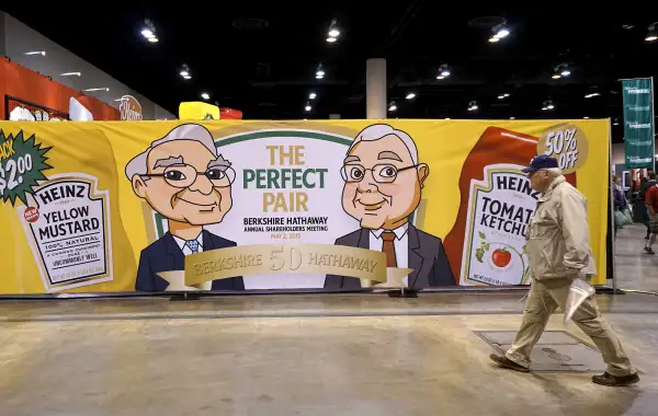 A Berkshire Hathaway shareholder walks by a Heinz company display at the shareholder's shopping day in Omaha, Nebraska May 1, 2015. Berkshire-owned Heinz was selling ketchup and mustard special editon bottles featuring images of Berkshire CEO Warren Buffett and Berkshire vice-chairman Charlie Munger.