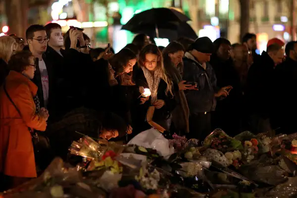 People light candles at a makeshift memorial at the place de la republique on November 17, 2015 in Paris, France. Paris remains under heightened security following terrorist attacks , which left at least 129 people dead and hundreds more injured.