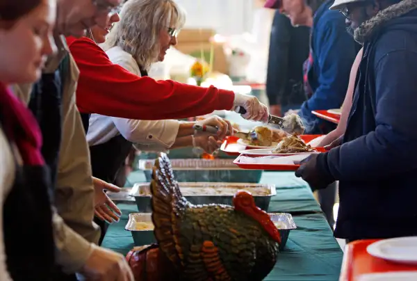 Volunteers help serve Thanksgiving meals during the 22nd annual Thanksgiving Day dinner hosted by St. Peter's Catholic Church and First Baptist Church of Columbia in Columbia, South Carolina, November 22, 2012.