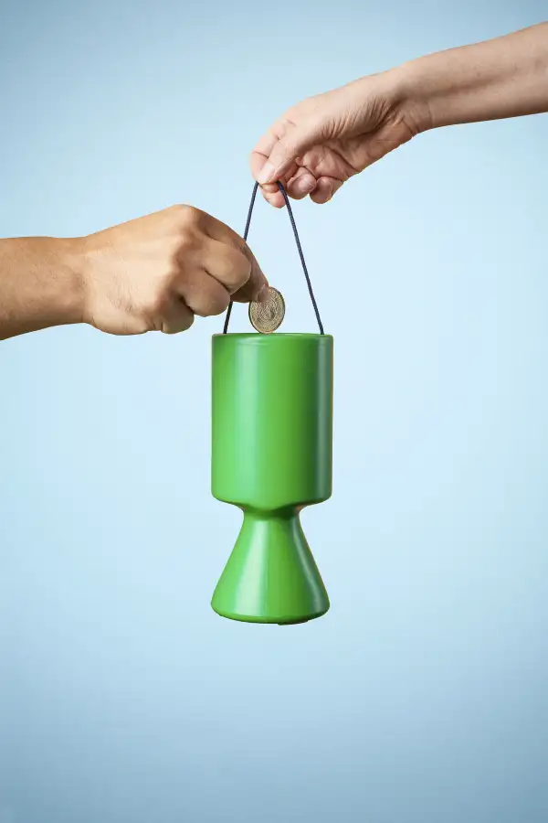 putting money in charity container