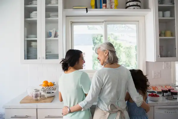 grandmother at sink with grandkids