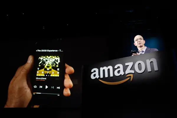 Amazon CEO Jeff Bezos shows off his company's new Fire smartphone at a news conference in Seattle, Washington June 18, 2014.