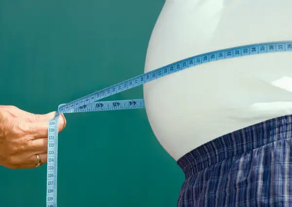 measuring tape around a man's belly
