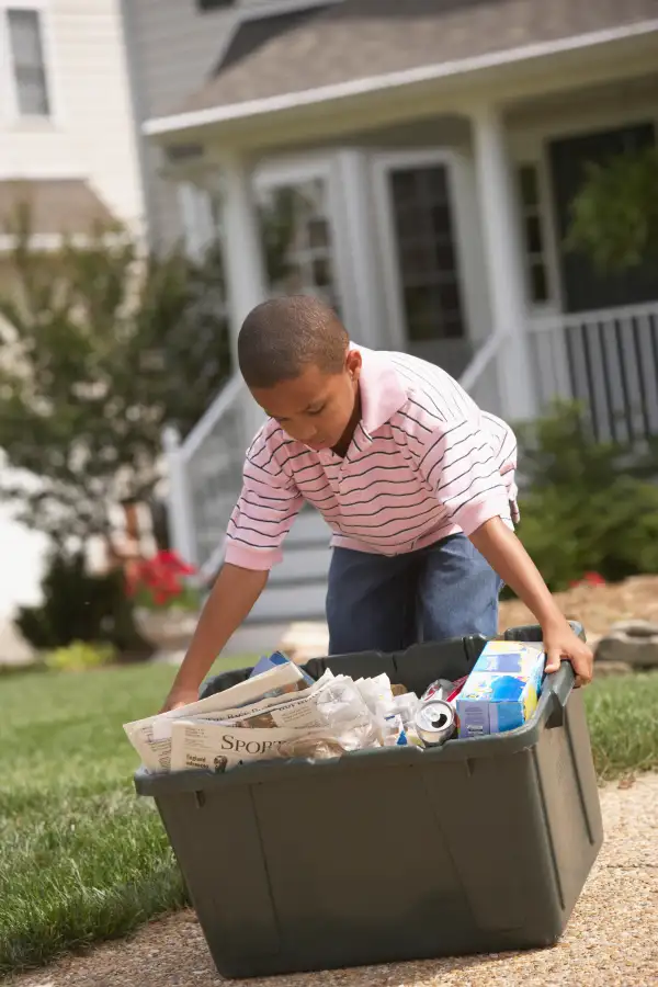 kid taking out recycling